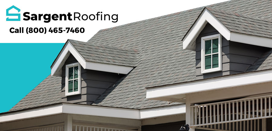 A gray shingled house roof with dormer windows in Utica, MI. Sargent Roofing, a trusted roofing contractor, displays its logo in the top left corner along with the phone number: Call (800) 465-7460.